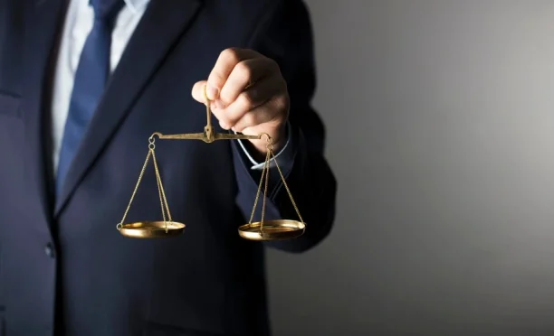 Lawyer holding justice scales symbolizing legal protection, 247lemonlaw