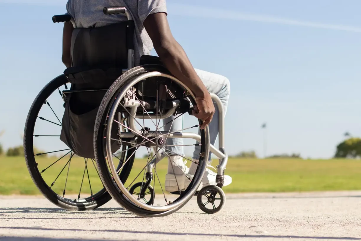 Man in a wheelchair outdoors after a serious injury, representing long-term disability and personal injury claims.