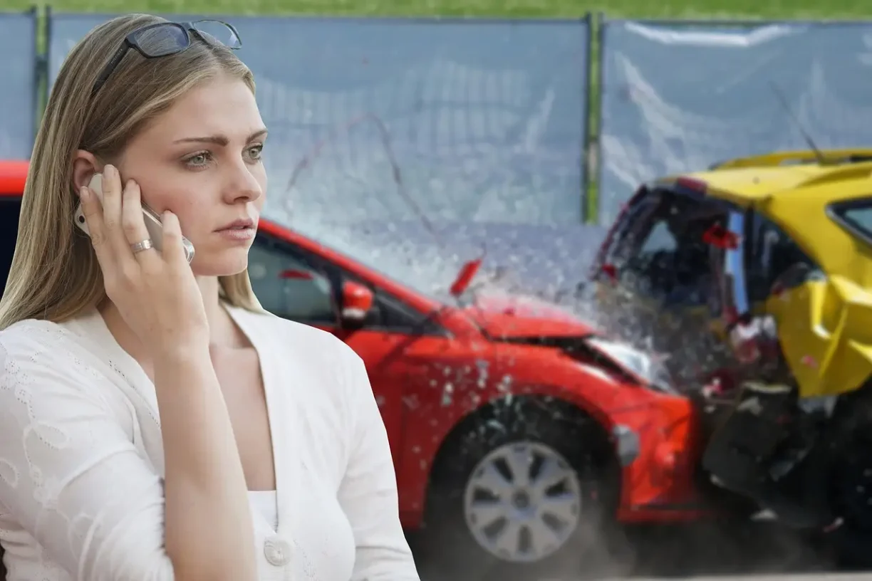 Woman calling for help after a car accident, with damaged vehicles visible at the crash scene.