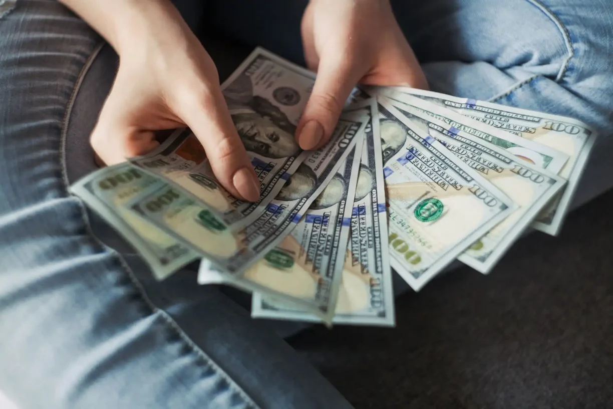 Employee holding overdue wages illustrating waiting time penalties California for late final paychecks