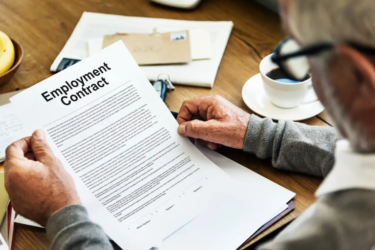 Worker reviewing an employment contract related to wages and job terms in California