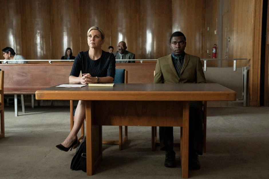 A professional attorney and client sitting at a defense table in a courtroom, representing the advocacy provided when hiring a personal injury lawyer.