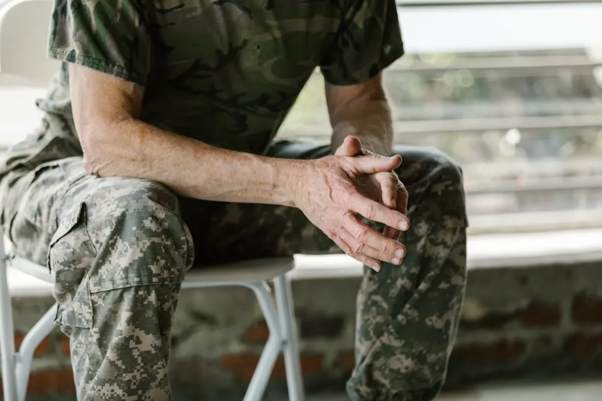 Military veteran reflecting on workplace rights and veterans day paid holiday benefits