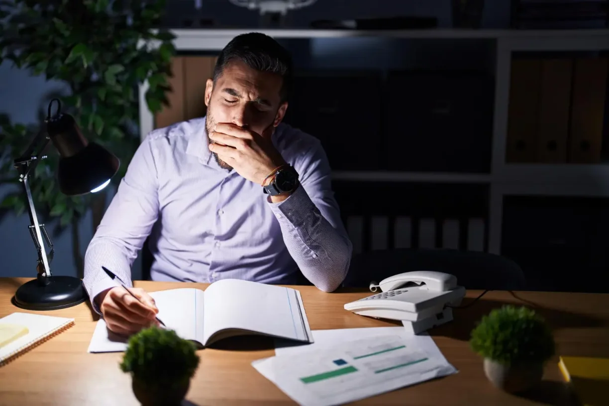 Non exempt vs exempt employee working late hours at office desk without overtime pay in California
