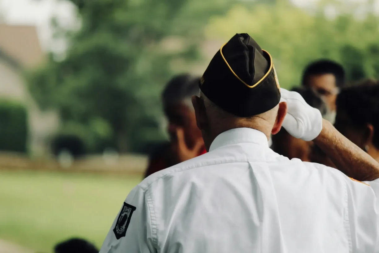 Veteran saluting during ceremony highlighting veterans day paid holiday protections