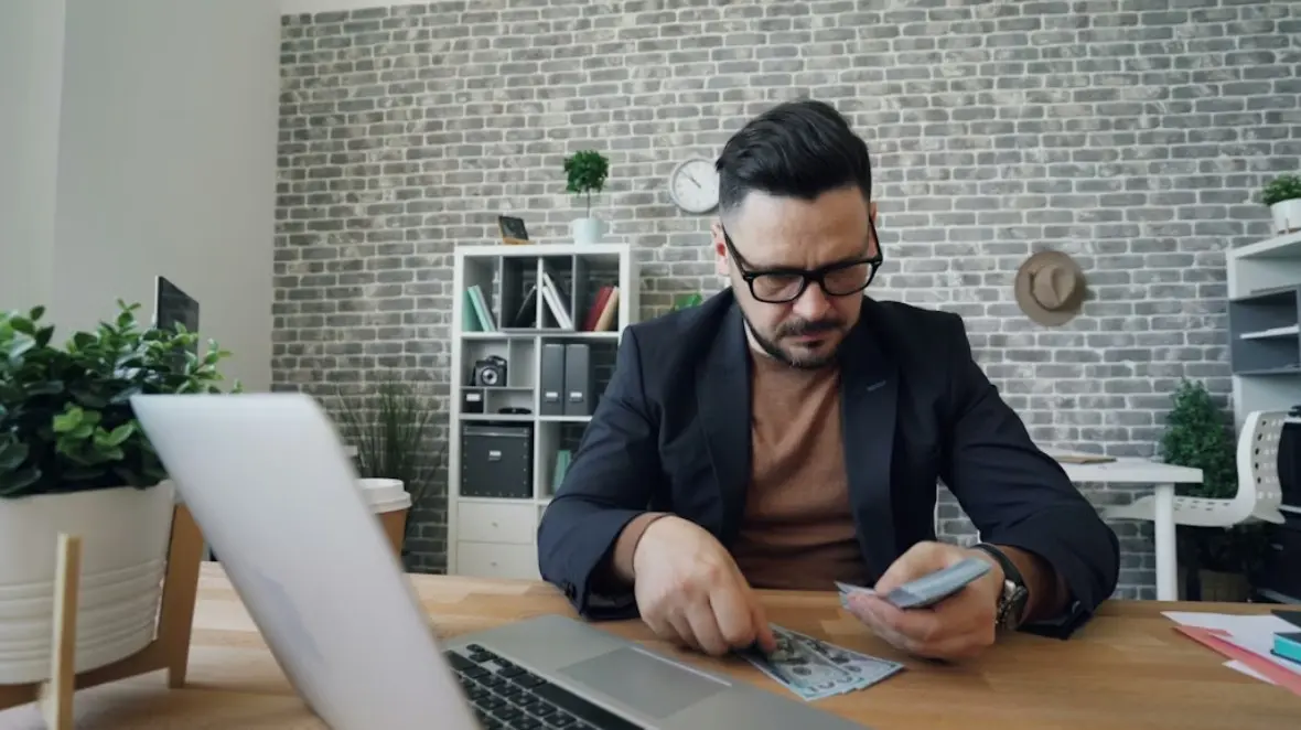California employee reviewing unpaid wages at desk to understand how to win a wage claim in California